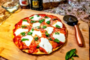 Pizza Margherita Finished on Cutting Board